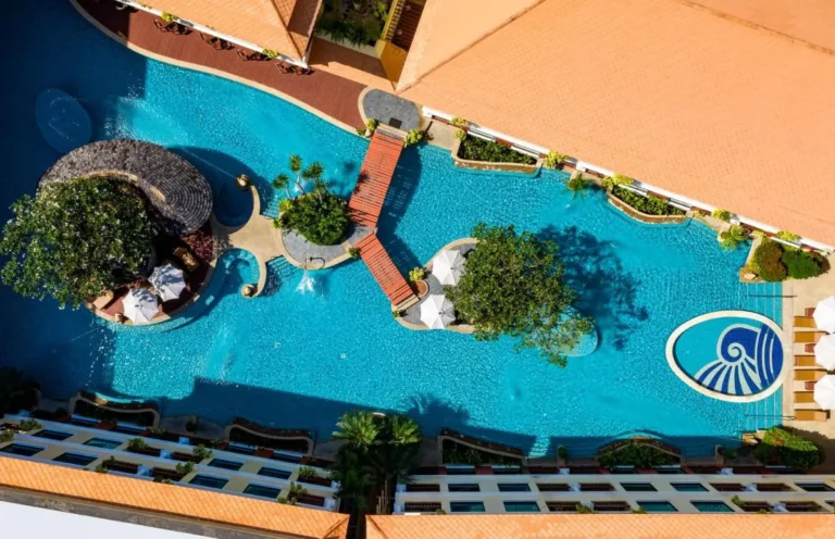Aerial View of Large Outdoor Swimming Pool with Islands and Lounge Areas at Patong Beach