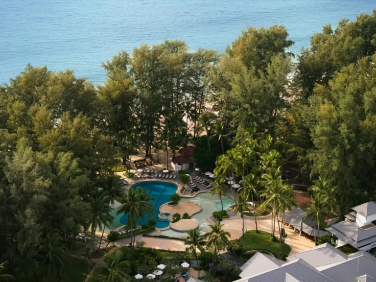 Aerial View of Large Resort Pool Complex Surrounded by Tropical Greenery at Bang Tao Beach
