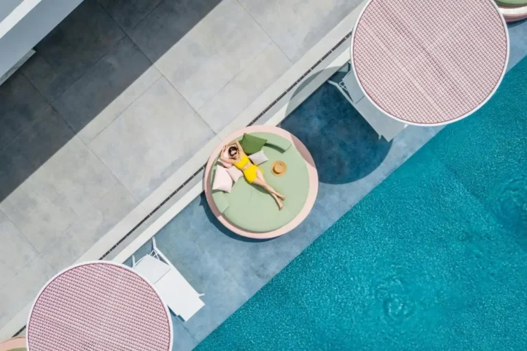 Aerial View of Modern Poolside Area with Circular Daybeds and Lounge Chairs at Panwa Beach