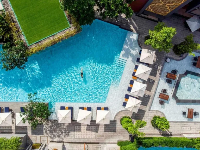 Aerial View of Outdoor Pool Area with Lounge Chairs and Fountain at Karon Beach