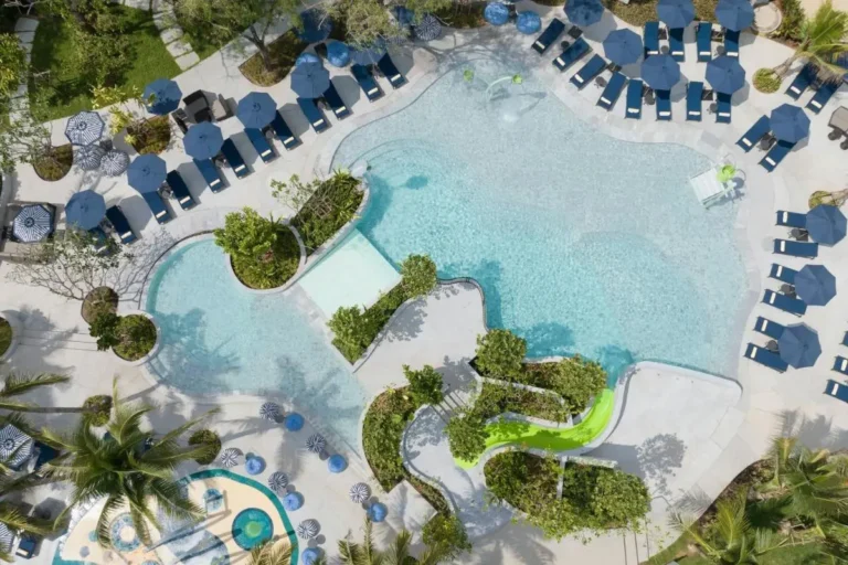 Aerial View of Outdoor Pool Area with Water Slide and Lounge Seating at Mai Khao Beach