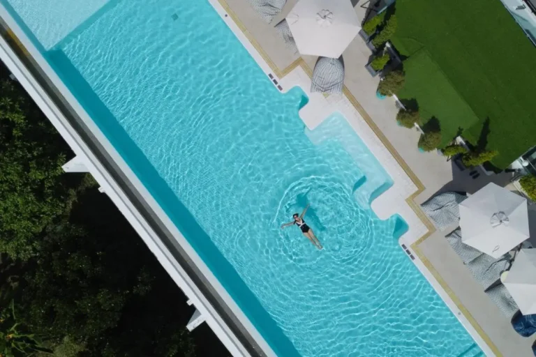 Aerial View of Outdoor Rectangular Swimming Pool with Lounge Chairs at Rawai Beach