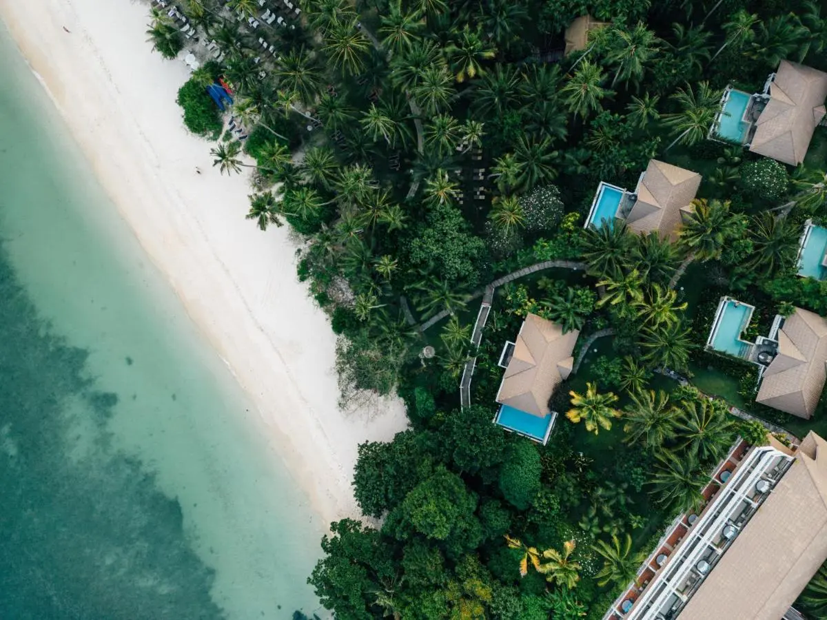 Aerial View of Private Pools and Beachfront Villas Surrounded by Tropical Vegetation at Panwa Beach