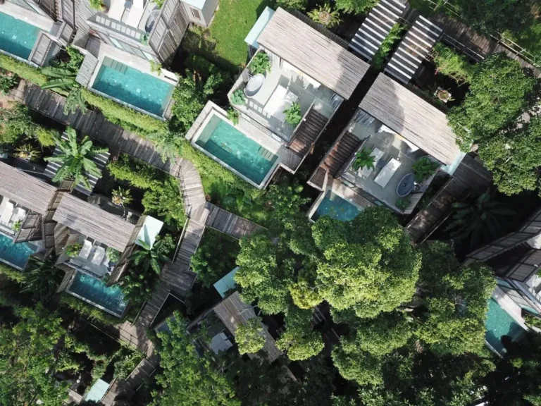 Aerial View of Private Pools and Wooden Decks Surrounded by Tropical Vegetation at Patong Beach