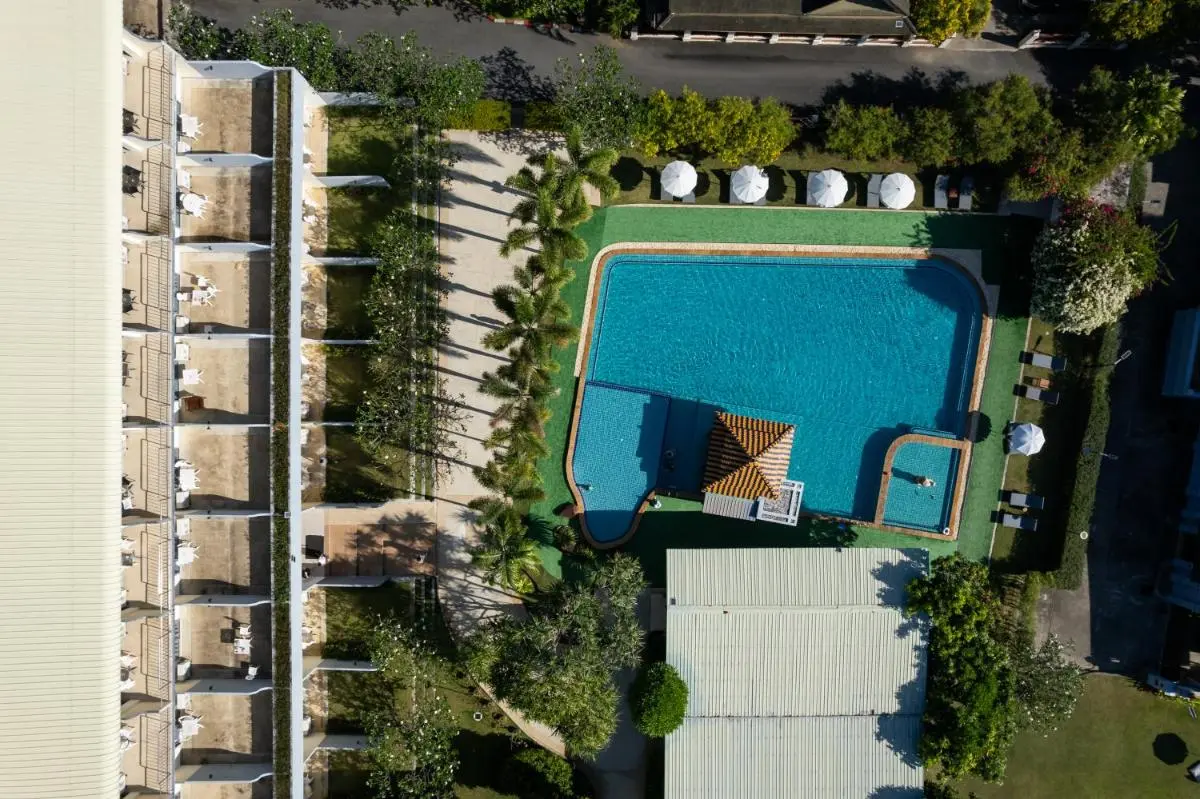 Blue Beach Grand Resort And Spa Aerial View of Rectangular Outdoor Swimming Pool Complex with Lounge Area and Greenery at Rawai Beach