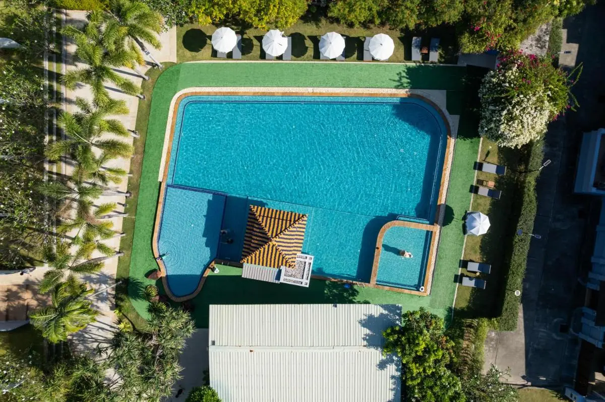 Aerial View of Rectangular Outdoor Swimming Pool with Shaded Lounge Areas at Rawai Beach