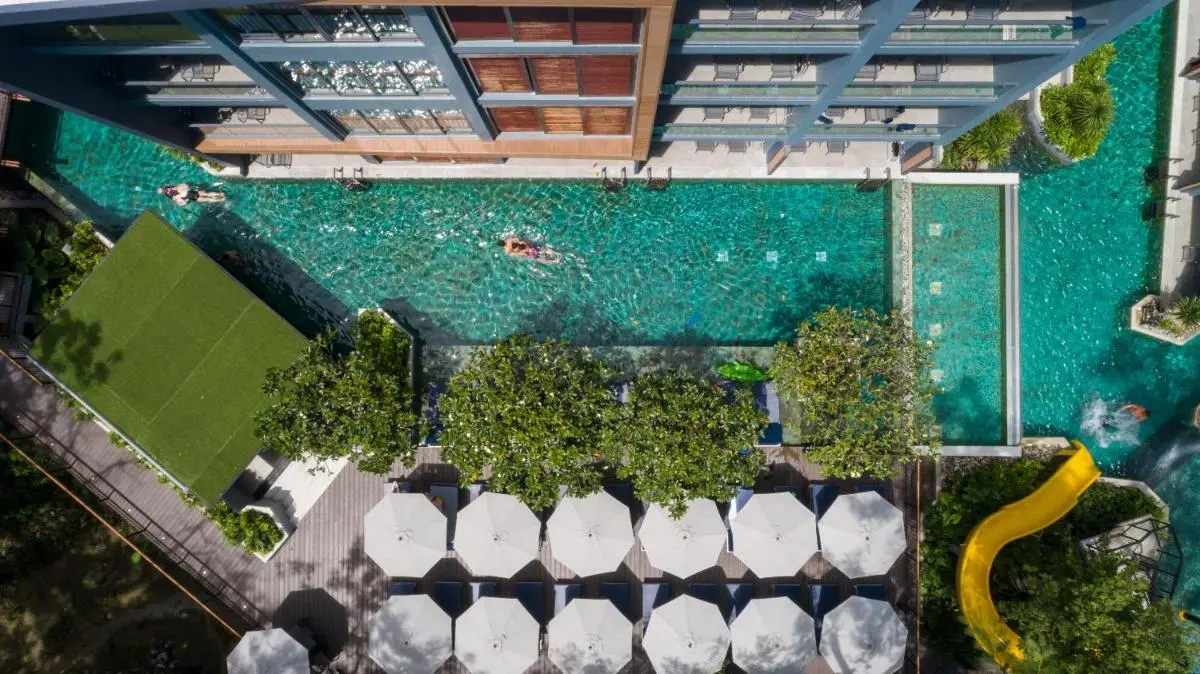 Aerial View of Rectangular Outdoor Swimming Pool with Water Slide and Lounge Area at Patong Beach