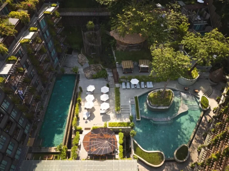 Aerial View of Two Distinct Swimming Pools with Sun Loungers and Cabanas at Patong Beach