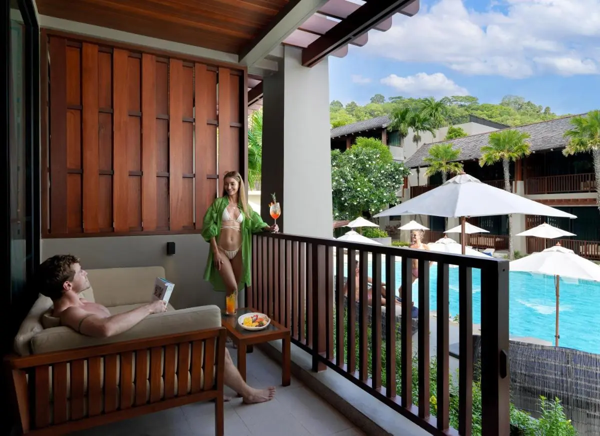 Balcony Overlooking Outdoor Swimming Pool with Lounge Area at Patong Beach