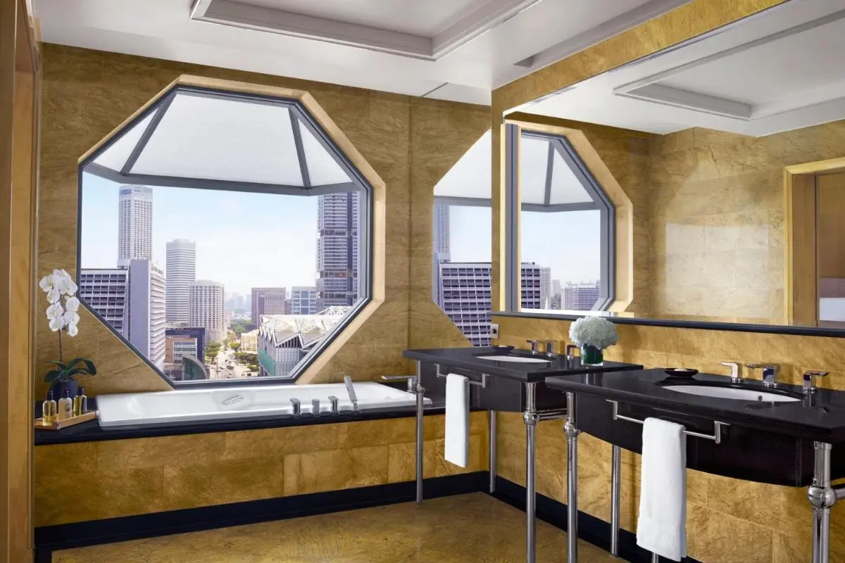 Bathroom with Bathtub and Double Sink Vanity Overlooking Marina Bay Cityscape