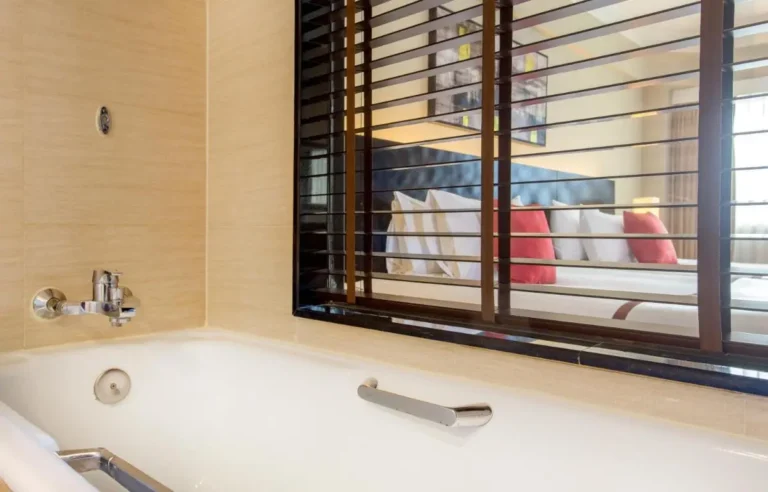 Bathroom with Bathtub and Interior Window Overlooking Bedroom in Bang Kho Laem