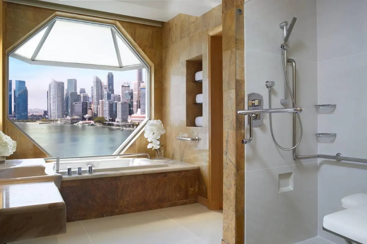 Bathtub and Shower Area with City View in Marina Bay Bathroom