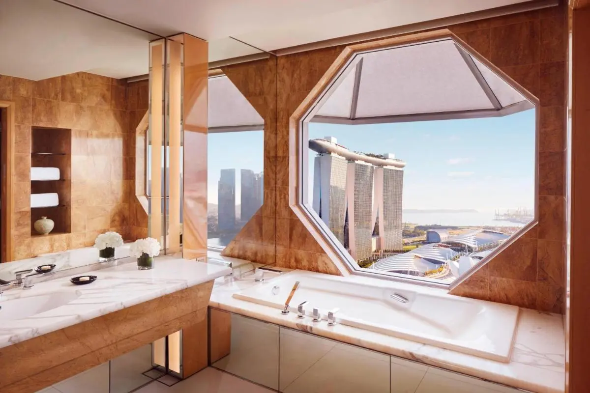 Bathtub with Octagonal Window Overlooking Marina Bay Cityscape and Waterfront View