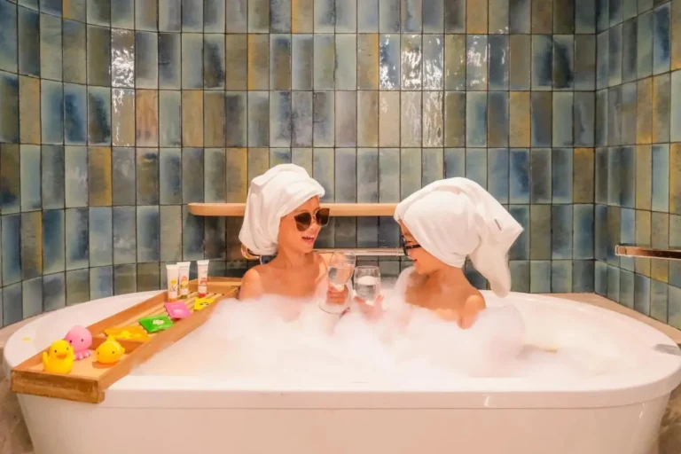 Children Enjoying Bubble Bath with Towels and Sunglasses in Modern Bathroom
