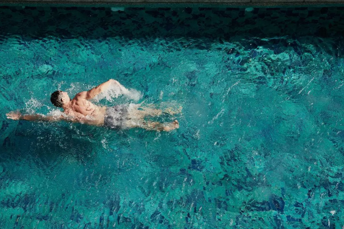 Clear Blue Rectangular Swimming Pool with Backstroke Swimmer in Sathorn City