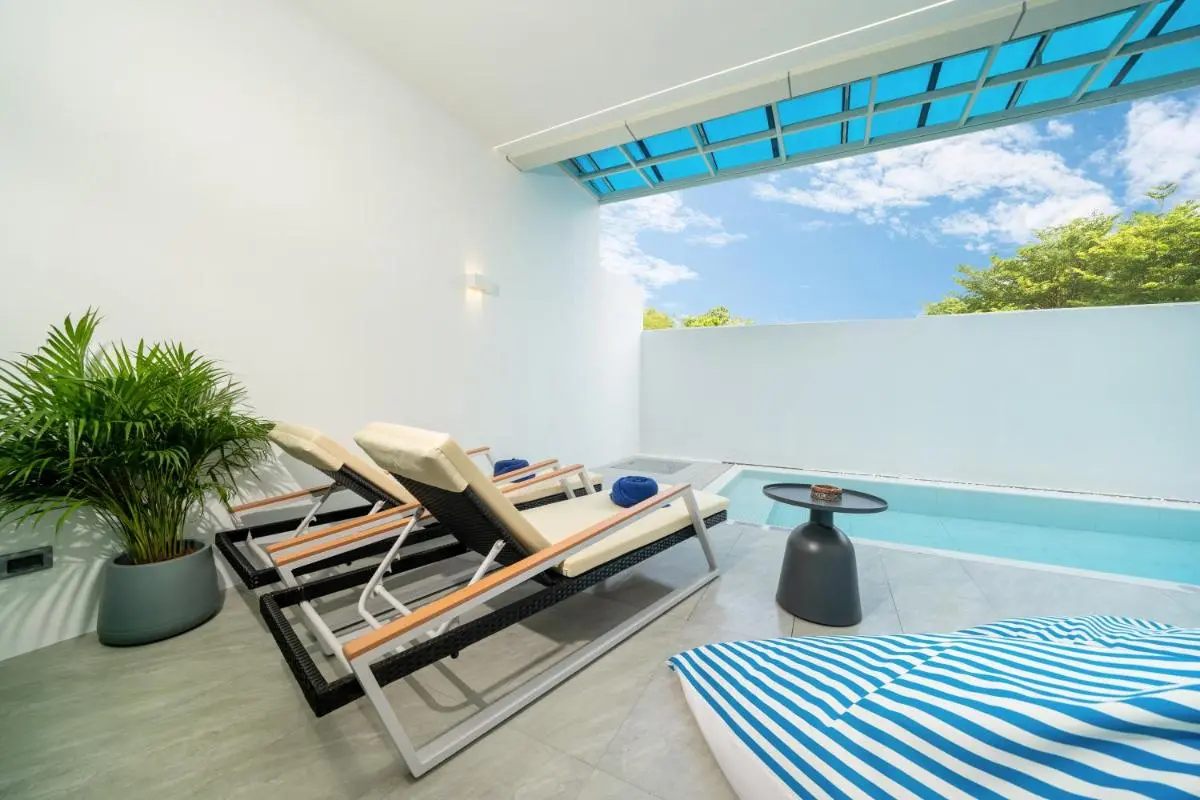 Compact Outdoor Wellness Area with Rectangular Pool and Lounge Seating at Rawai Beach