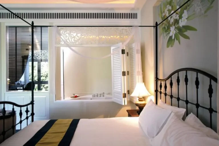 Cozy Bedroom with Built-In Bathtub and Floral Decor in Chang Khlan Chiang Mai