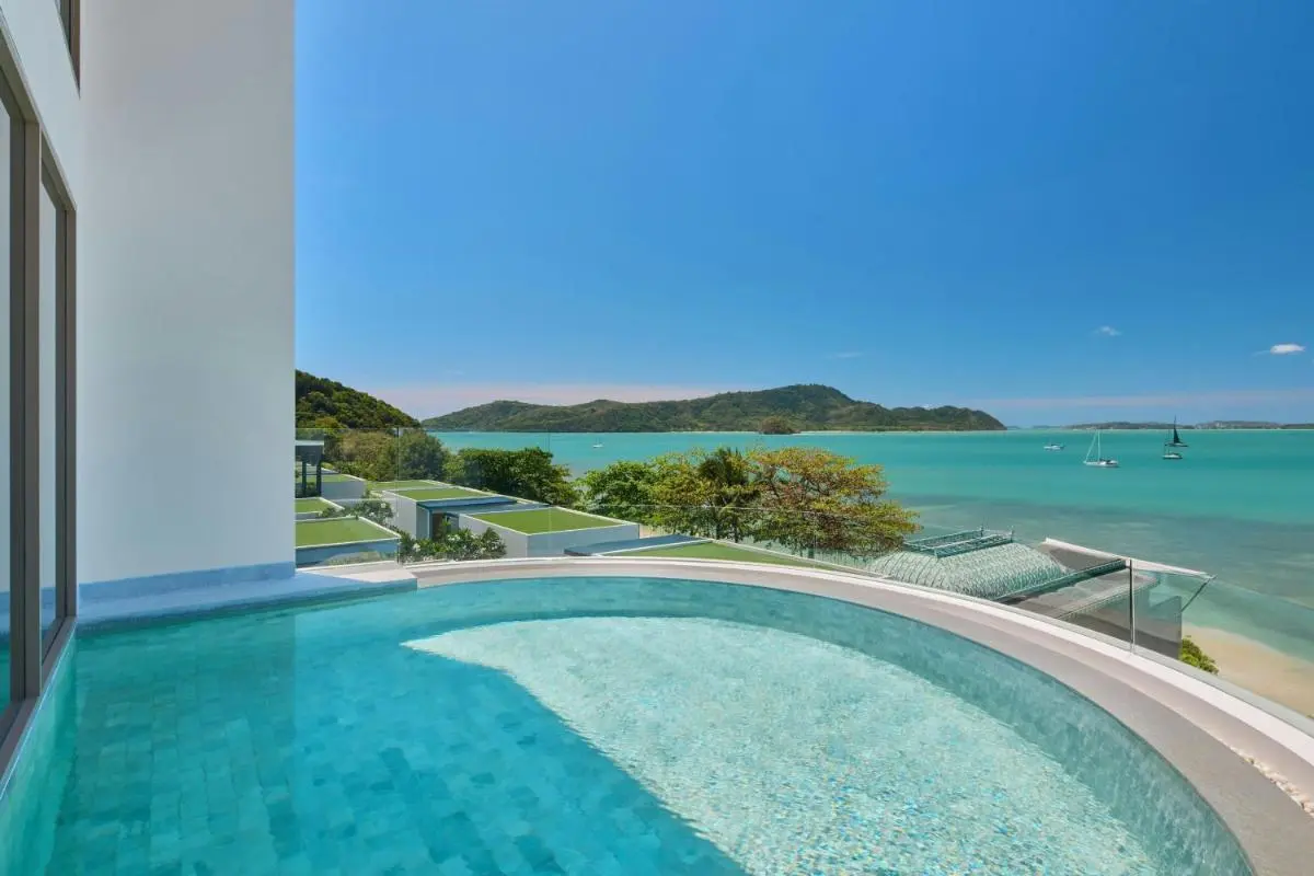 Veranda Resort Phuket, Autograph Collection Curved Elevated Swimming Pool Overlooking Turquoise Waters and Forested Hills at Panwa Beach