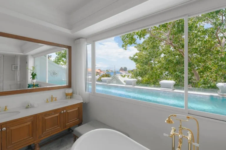 Elegant Bathroom with Gold Fixtures and Outdoor Pool View in Phra Sing Chiang Mai