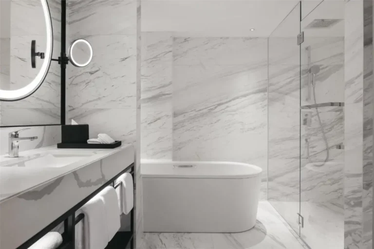 Elegant Bathroom with Marble Tiles and Freestanding Bathtub in Orchard