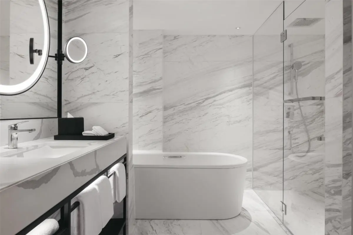 Elegant Bathroom with Marble Tiles and Freestanding Bathtub in Orchard