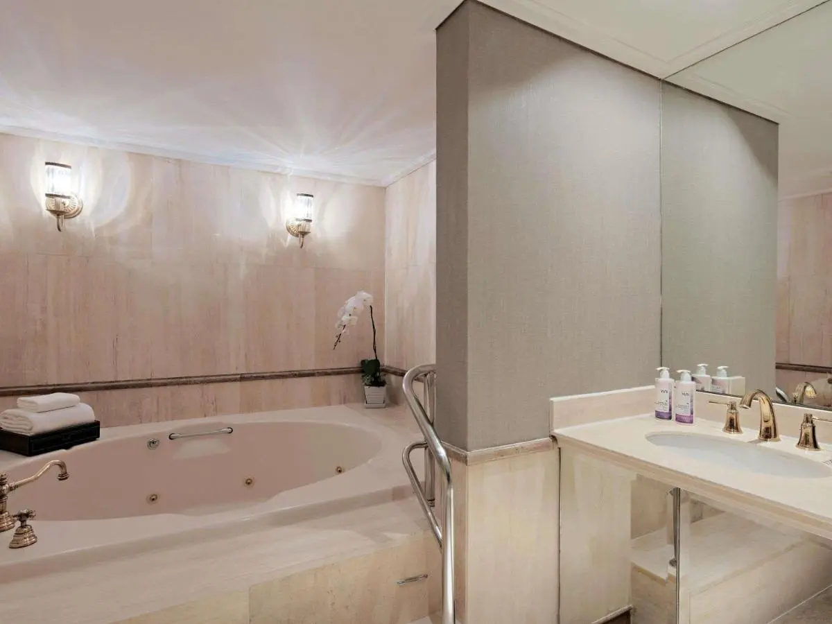 Mövenpick BDMS Wellness Resort Bangkok Elegant Beige Marble Whirlpool Bathtub and Sink Area in Pathumwan Bathroom