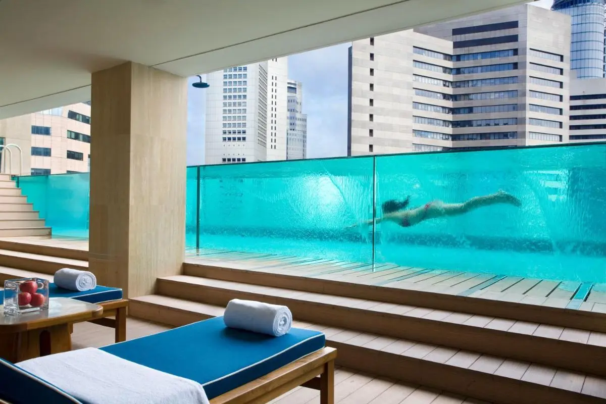 Elevated Glass-Walled Pool and Lounge Area with City Views in Marina Bay