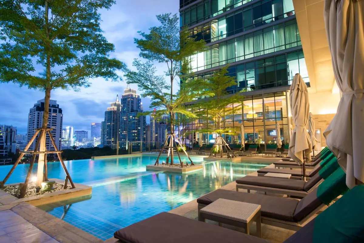 Elevated Outdoor Pool Area with Lounge Seating and City Views in Pathumwan Bangkok