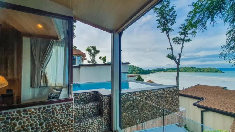 Elevated Outdoor Pool with Stone Border and Scenic Coastal View in Phuket Town