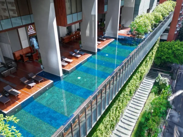 Elevated Rectangular Swimming Pool and Wellness Area with Urban Greenery in Pathumwan Bangkok