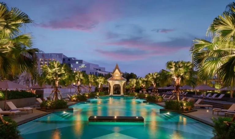 Evening View of Outdoor Swimming Pool with Pavilion and Palm Trees in Ratchathewi Bangkok