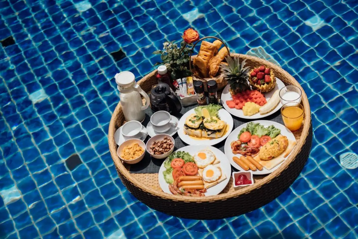 Floating Breakfast Tray with Fresh Food and Drinks on Blue Tiled Pool at Rawai Beach