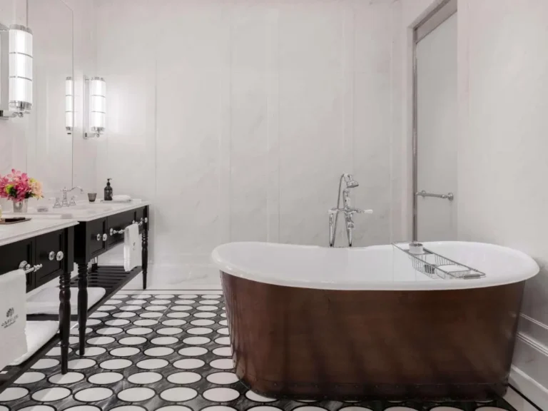 Freestanding Bathtub and Double Vanity Bathroom with Patterned Floor in City Hall