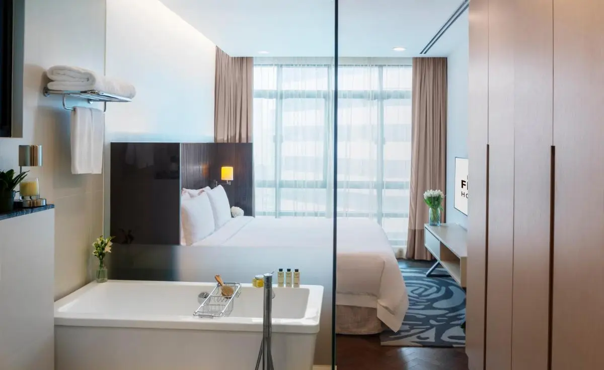 Hotel Room with Bathtub and Glass Partition in Singapore City Center