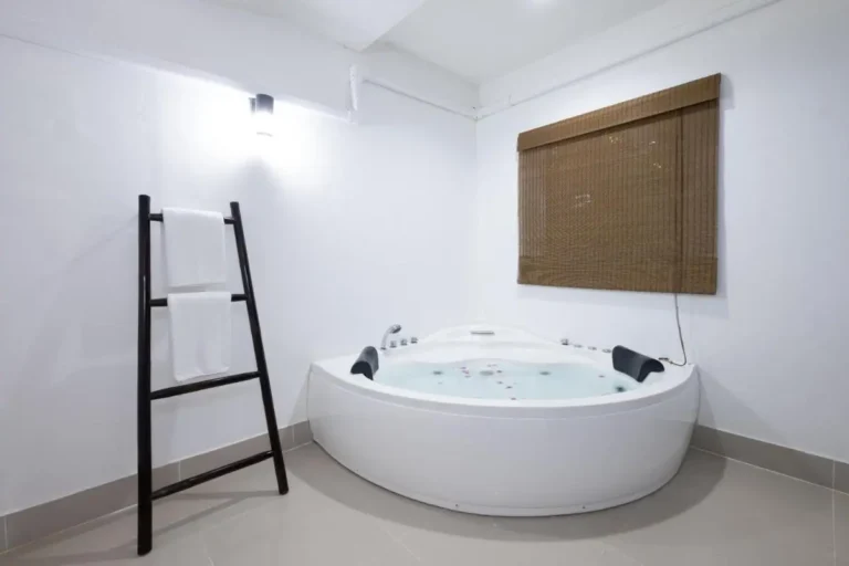 Indoor Corner Jacuzzi Tub with Dual Headrests and Towel Rack at Rawai Beach