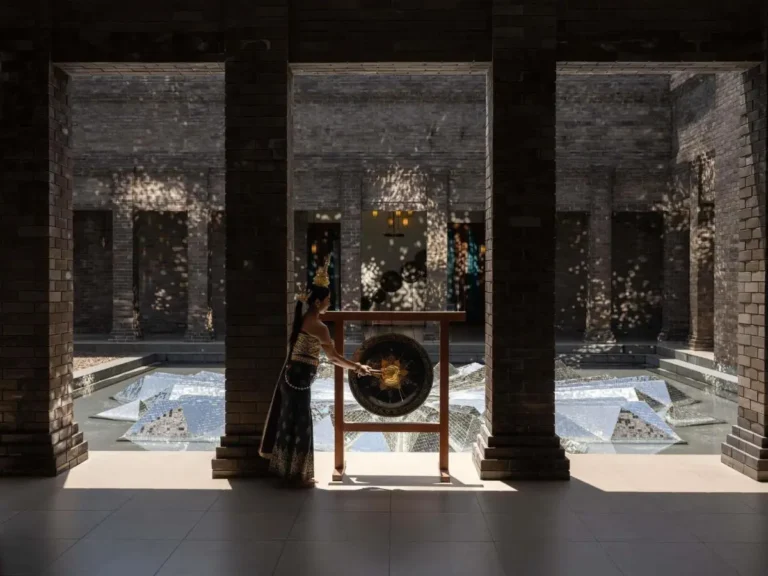 Indoor Courtyard with Reflective Mosaic Pool and Traditional Gong at Patong Beach