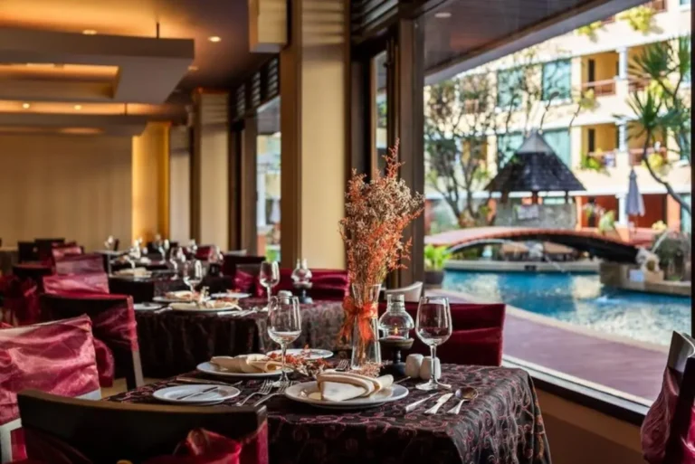 Indoor Dining Area Overlooking Curved Outdoor Pool with Bridge at Patong Beach