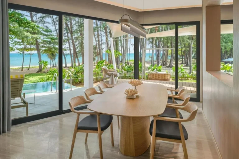 Indoor Dining Area Overlooking Small Pool and Beach at Mai Khao Beach