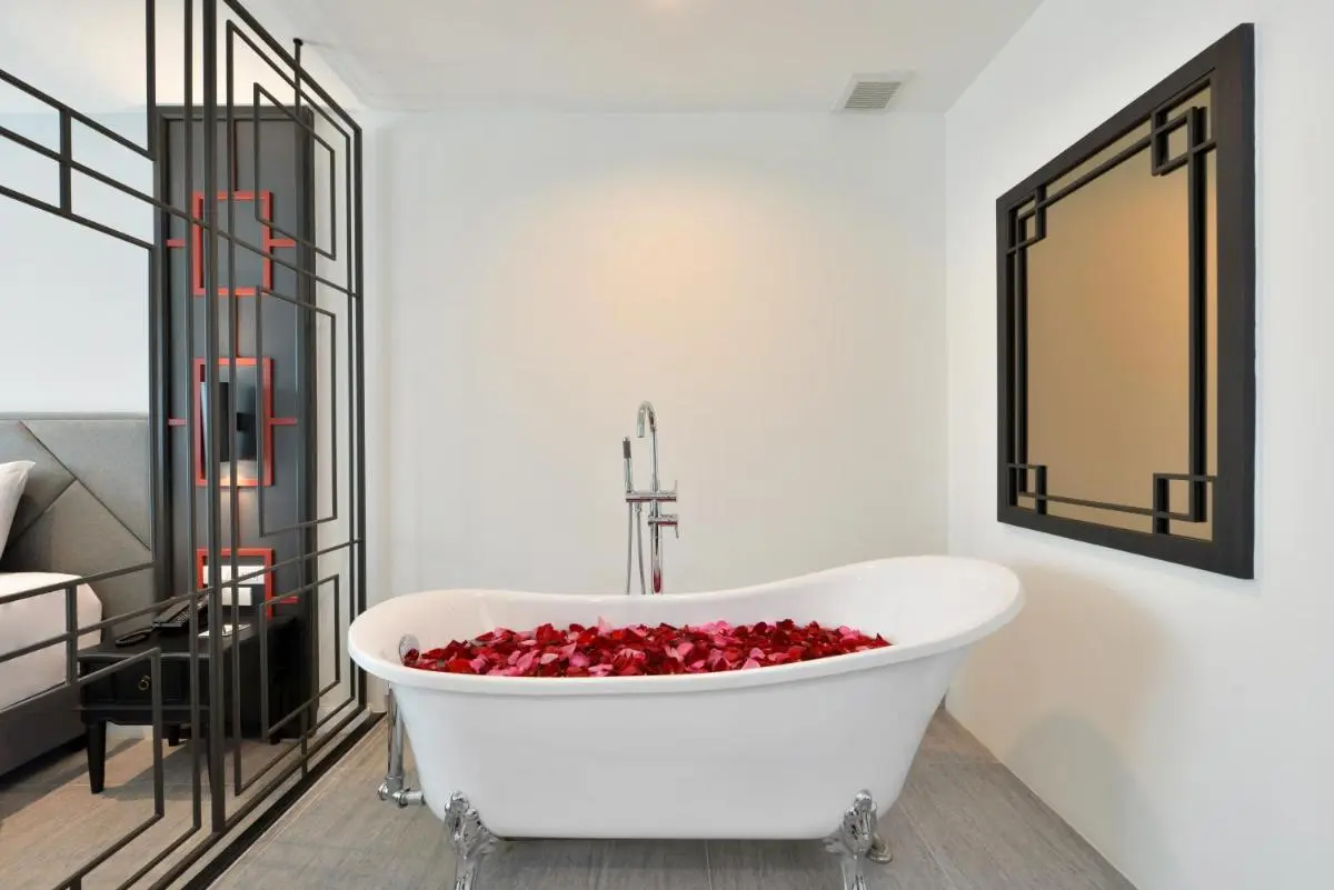 Indoor Freestanding Bathtub with Flower Petals and Modern Fixtures in Phra Nakhon