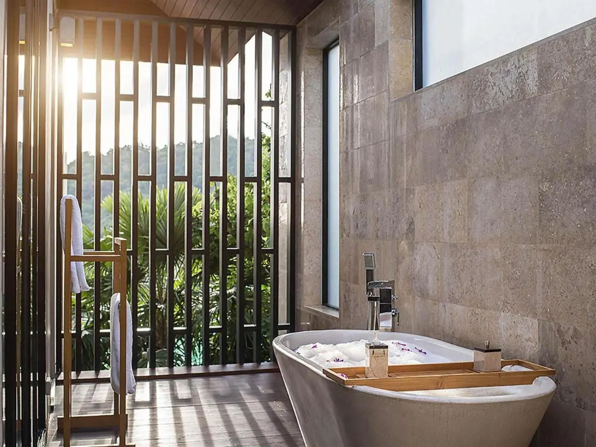 Indoor Freestanding Bathtub with Natural Stone Walls and Scenic Views at Patong Beach