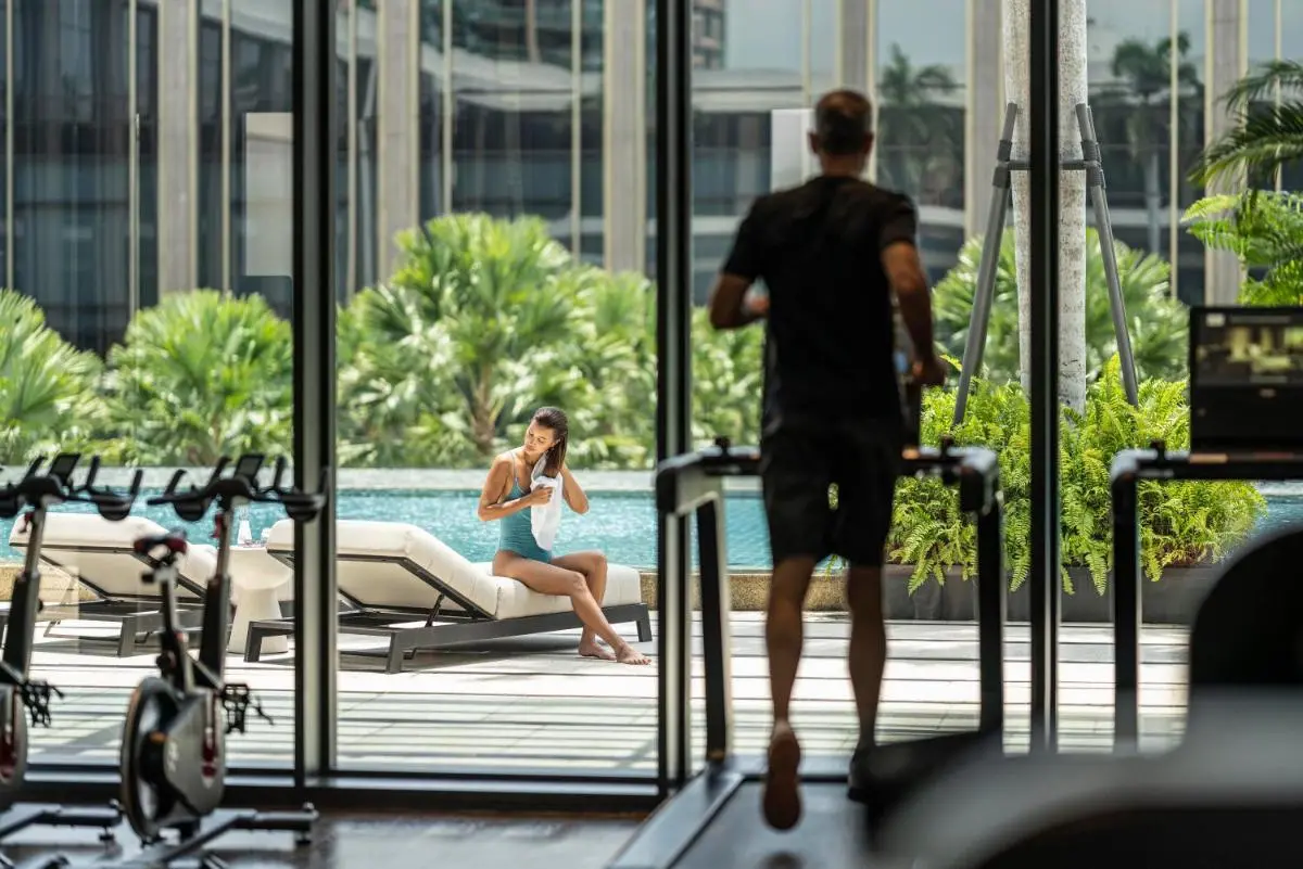 Indoor Gym and Outdoor Pool Area with Jacuzzi and Greenery in Sathorn Bangkok