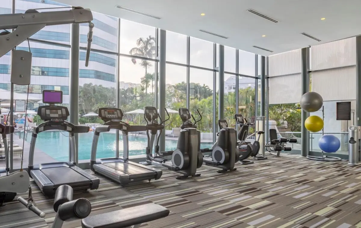 Fraser Suites Singapore Indoor Gym with Outdoor Pool View and Fitness Equipment in Singapore