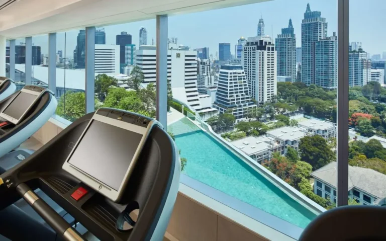Indoor Gym with Treadmills and Elevated Pool Overlooking Pathumwan Cityscape
