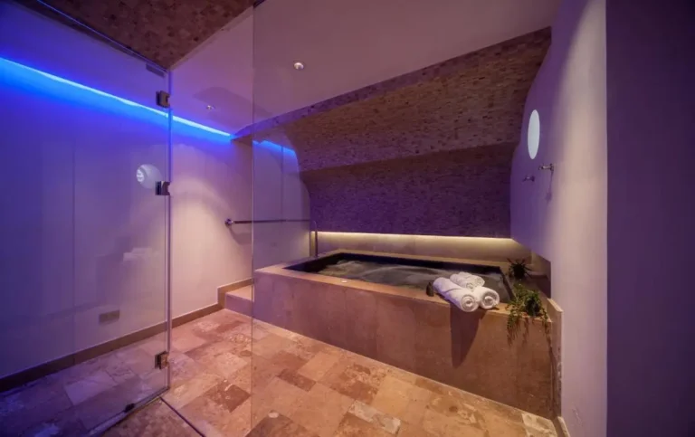 Indoor Jacuzzi and Spa Area with Stone Tiles and Ambient Lighting in Pathumwan