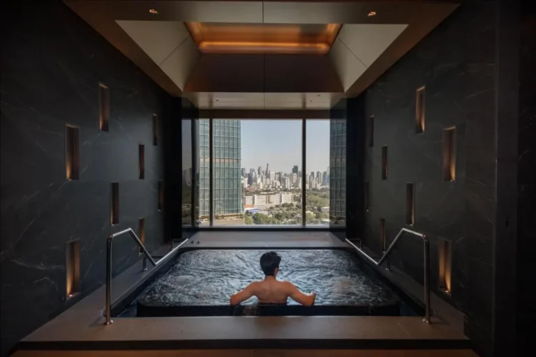 Indoor Jacuzzi with Urban Skyline View and Ambient Lighting in Sathorn Wellness Room