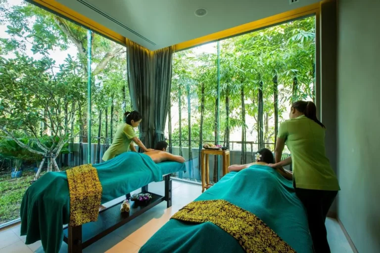 Indoor Massage Room with Dual Tables and Large Glass Windows Overlooking Greenery at Patong Beach