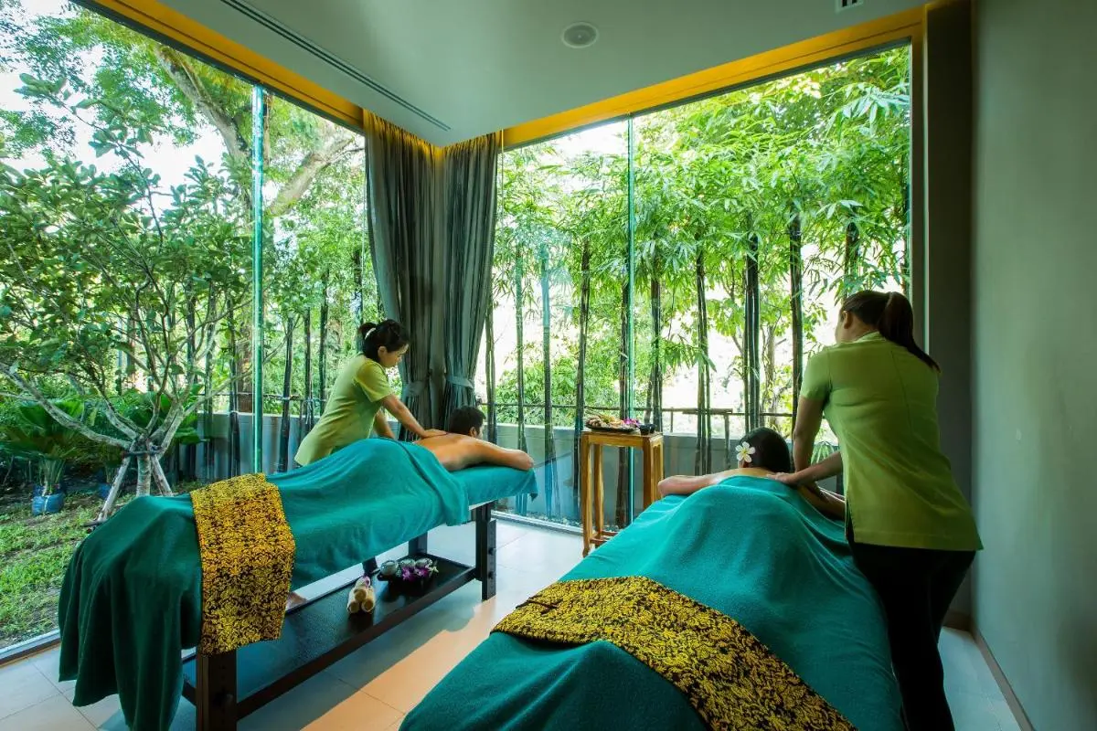 Indoor Massage Room with Dual Tables and Large Glass Windows Overlooking Greenery at Patong Beach