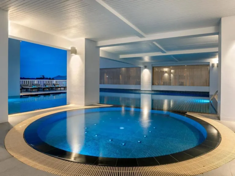 Indoor Pool and Jacuzzi Area with Modern Design and Scenic Outdoor Views in Phuket Town