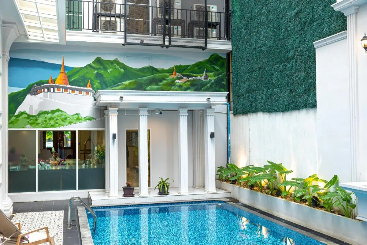 Indoor Pool Area with Blue Mosaic Tiles and Classical Columns in Phra Nakhon