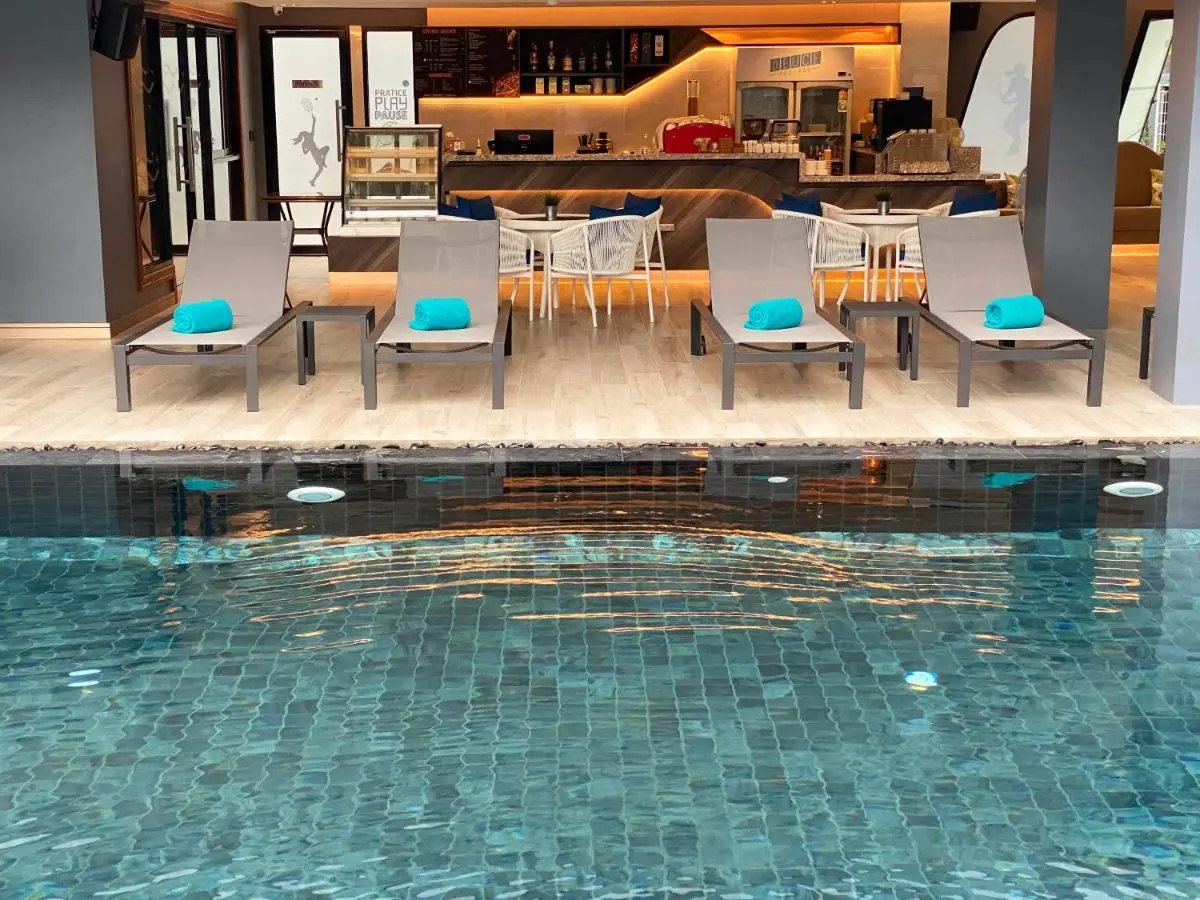 Indoor Pool Area with Lounge Seating and Modern Bar in Phuket Town